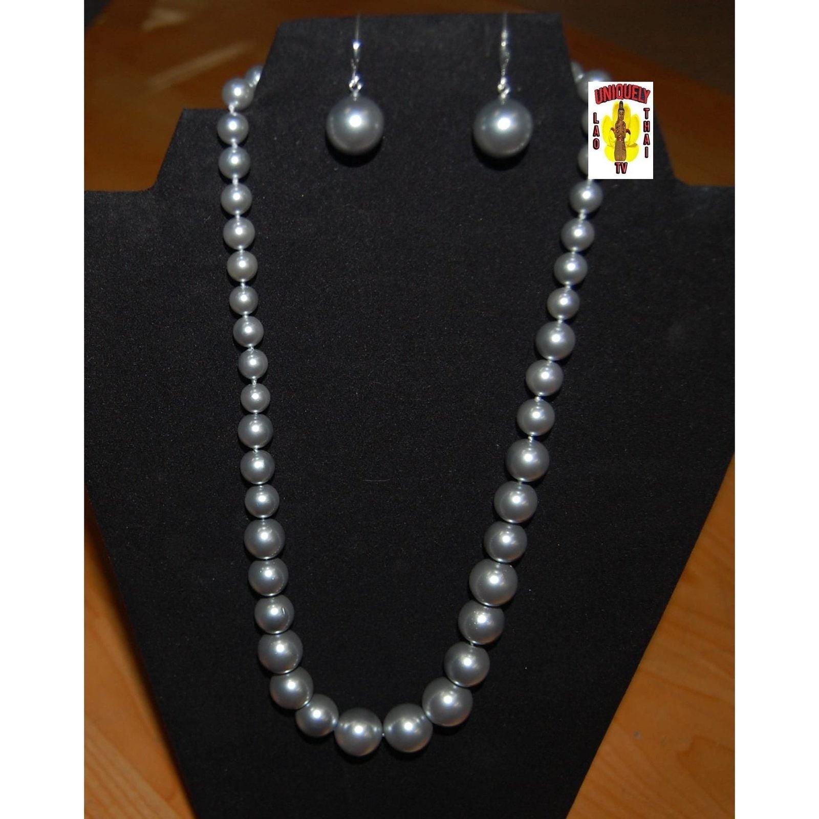 South Sea Pearl Jewelry Set featuring a necklace and earrings on a display, showcasing elegant pearls with natural luster.